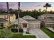Charming single-story home boasts a two-car garage, neutral paint, and lush landscaping at 9534 Piccadilly Sky Way, Orlando, FL 32827
