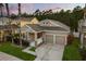 Charming home with a two-car garage, stone accents, manicured lawn, and inviting entryway at 9534 Piccadilly Sky Way, Orlando, FL 32827