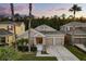 Inviting home featuring a two-car garage, beautifully landscaped front yard, and a welcoming entrance at 9534 Piccadilly Sky Way, Orlando, FL 32827