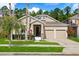 Charming two-story home features a well-manicured lawn, a two-car garage, and lovely landscaping at 9534 Piccadilly Sky Way, Orlando, FL 32827