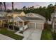 Beautifully landscaped home with a two-car garage and a charming entrance, perfect for Gathering living at 9534 Piccadilly Sky Way, Orlando, FL 32827