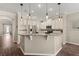 Well-lit kitchen boasts stainless steel appliances, granite countertops, pendant lighting, and wooden floors at 9534 Piccadilly Sky Way, Orlando, FL 32827
