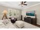 Bright living room featuring stylish furniture, large windows with plantation shutters, and modern entertainment setup at 9534 Piccadilly Sky Way, Orlando, FL 32827