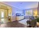 Spacious living room featuring an aquarium, plantation shutters, neutral paint, and entryway view at 9534 Piccadilly Sky Way, Orlando, FL 32827
