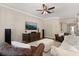 Comfortable living room with plush seating, ceiling fan, and a large screen television at 9534 Piccadilly Sky Way, Orlando, FL 32827