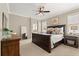 Spacious main bedroom with a large bed, dark wood furniture, and a neutral color palette at 9534 Piccadilly Sky Way, Orlando, FL 32827