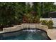 A peaceful pool with stone waterfall and lush landscaping create an inviting ambiance at 9534 Piccadilly Sky Way, Orlando, FL 32827