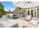 Inviting backyard pool with patio seating and umbrella, perfect for outdoor relaxation and entertaining at 9534 Piccadilly Sky Way, Orlando, FL 32827