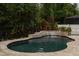 Beautiful backyard pool with a waterfall feature and lush tropical landscaping, ideal for relaxation at 9534 Piccadilly Sky Way, Orlando, FL 32827