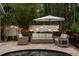 Inviting poolside patio area with comfortable seating and an umbrella, perfect for relaxing by the pool and enjoying outdoors at 9534 Piccadilly Sky Way, Orlando, FL 32827