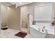 Bright bathroom featuring a walk-in shower and a garden tub at 1022 Pinehurst Ct, Oviedo, FL 32765