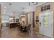 Inviting entryway and dining area with wood floors, pendant lighting, and a charming front door at 1022 Pinehurst Ct, Oviedo, FL 32765