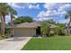 Charming single-story home with well-manicured lawn, mature trees, and an attached two-car garage at 1022 Pinehurst Ct, Oviedo, FL 32765