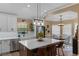 Open concept kitchen featuring a large island with bar stools, stainless steel appliances and ample natural light at 1022 Pinehurst Ct, Oviedo, FL 32765