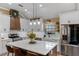 Modern kitchen with white cabinets, a central island with bar seating, and stainless steel appliances at 1022 Pinehurst Ct, Oviedo, FL 32765
