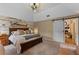 Comfortable bedroom showcasing a decorative accent wall and a stylish sliding barn door at 1022 Pinehurst Ct, Oviedo, FL 32765