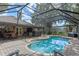 Inviting screened-in pool area with ample seating, perfect for outdoor entertaining and relaxation at 1022 Pinehurst Ct, Oviedo, FL 32765