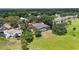 Expansive aerial view of home with large screened in pool and spacious yard, backing up to lush greenery at 1093 Hidden Harbor Ln, Kissimmee, FL 34746