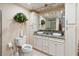 Well-lit bathroom with double sinks, granite countertops and modern fixtures at 1093 Hidden Harbor Ln, Kissimmee, FL 34746