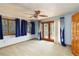 Bedroom featuring double windows, ceiling fan, patio access, and closet at 1093 Hidden Harbor Ln, Kissimmee, FL 34746