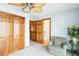Bedroom featuring double closet, floral arrangement, ceiling fan, and easy access to bath at 1093 Hidden Harbor Ln, Kissimmee, FL 34746