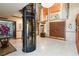 Grand foyer featuring a glass elevator, marble floors, double doors and a high ceiling at 1093 Hidden Harbor Ln, Kissimmee, FL 34746