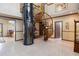 Grand foyer showcasing a winding staircase and a unique glass elevator at 1093 Hidden Harbor Ln, Kissimmee, FL 34746