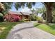 Brick paved driveway with mature landscaping surrounding the attractive two-story home at 1093 Hidden Harbor Ln, Kissimmee, FL 34746