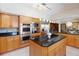 Gourmet kitchen with stainless steel appliances, a center island, and plentiful cabinetry at 1093 Hidden Harbor Ln, Kissimmee, FL 34746