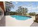 Beautiful screened-in pool featuring a view of mature landscaping, clear blue skies, and an outdoor shed at 1093 Hidden Harbor Ln, Kissimmee, FL 34746