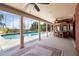 Gorgeous screened-in pool with an outdoor bar area, ceiling fans, and views of the surrounding yard at 1093 Hidden Harbor Ln, Kissimmee, FL 34746