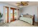 Comfortable sitting area with daybed, view of patio through French doors and large fan at 1093 Hidden Harbor Ln, Kissimmee, FL 34746