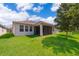 Spacious backyard with well-maintained lawn, white home exterior, and screened-in patio at 11054 Cyrilla Woods Dr, Orlando, FL 32832