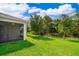 Well manicured lawn surrounding a screened patio in the backyard of a home at 11054 Cyrilla Woods Dr, Orlando, FL 32832