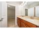 The bathroom features a double sink with wood cabinets and granite countertops, located next to a bedroom at 11054 Cyrilla Woods Dr, Orlando, FL 32832