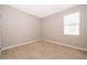 The bedroom features neutral walls, plush carpeting, and a bright window at 11054 Cyrilla Woods Dr, Orlando, FL 32832