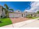 Charming one-story home featuring a brick driveway, landscaped front yard, and a two-car garage at 11054 Cyrilla Woods Dr, Orlando, FL 32832