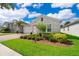 Delightful single-Gathering home with a brick driveway, manicured landscaping, and a two-car garage at 11054 Cyrilla Woods Dr, Orlando, FL 32832
