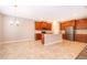 Bright kitchen features an island, stainless steel appliances, and elegant tile flooring at 11054 Cyrilla Woods Dr, Orlando, FL 32832