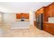 Spacious kitchen with stainless steel appliances, island, and warm wood cabinets at 11054 Cyrilla Woods Dr, Orlando, FL 32832