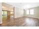 The living room is bright with windows, hardwood floors, and access to a screened in porch at 11054 Cyrilla Woods Dr, Orlando, FL 32832