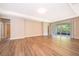 Bright living room features hardwood floors, recessed lighting, and sliding glass doors to the outdoors at 11054 Cyrilla Woods Dr, Orlando, FL 32832