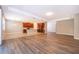This open concept living space showcases wood floors, recessed lighting, and a kitchen with dark cabinets at 11054 Cyrilla Woods Dr, Orlando, FL 32832