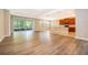 The home features an open floor plan with hardwood floors, sliding glass doors, and a kitchen with wooden cabinets at 11054 Cyrilla Woods Dr, Orlando, FL 32832