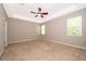 Bright main bedroom with carpet, ceiling fan, and many windows at 11054 Cyrilla Woods Dr, Orlando, FL 32832
