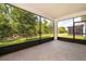 Screened in patio with black trim overlooking the yard in a beautiful home at 11054 Cyrilla Woods Dr, Orlando, FL 32832