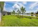 Expansive backyard with a scenic pond view and young pine trees, perfect for outdoor activities and relaxation at 1167 Celery Oaks Ln, Sanford, FL 32771