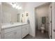 Bathroom features double sinks, white cabinets, toilet, and a shower at 1167 Celery Oaks Ln, Sanford, FL 32771