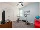 Bedroom with blue accent wall, TV, exercise bike, and exercise equipment at 1167 Celery Oaks Ln, Sanford, FL 32771