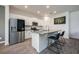 Modern kitchen with stainless steel appliances, a spacious island with seating, and sleek gray countertops at 1167 Celery Oaks Ln, Sanford, FL 32771